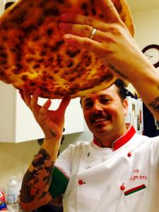 Tony Gemignani inspects a pizza
